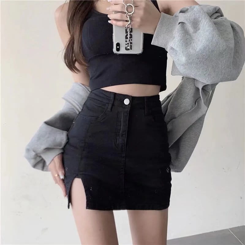 black high-waisted denim skirt with distressed detailing, side slit, and front button closure made from black denim.
