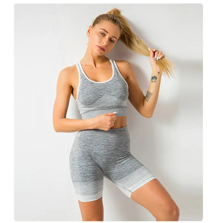 gray heathered seamless yoga workout set for women with hip lifting design, white trim, and ribbed texture