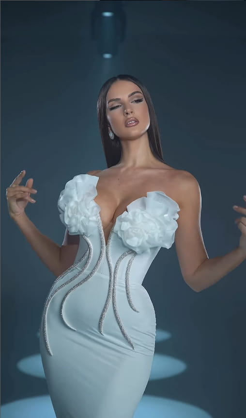a white temperament socialite corset-style evening dress featuring large floral embellishments at the bust and silver beaded trim along the sides showcasing the socialite flower chain design