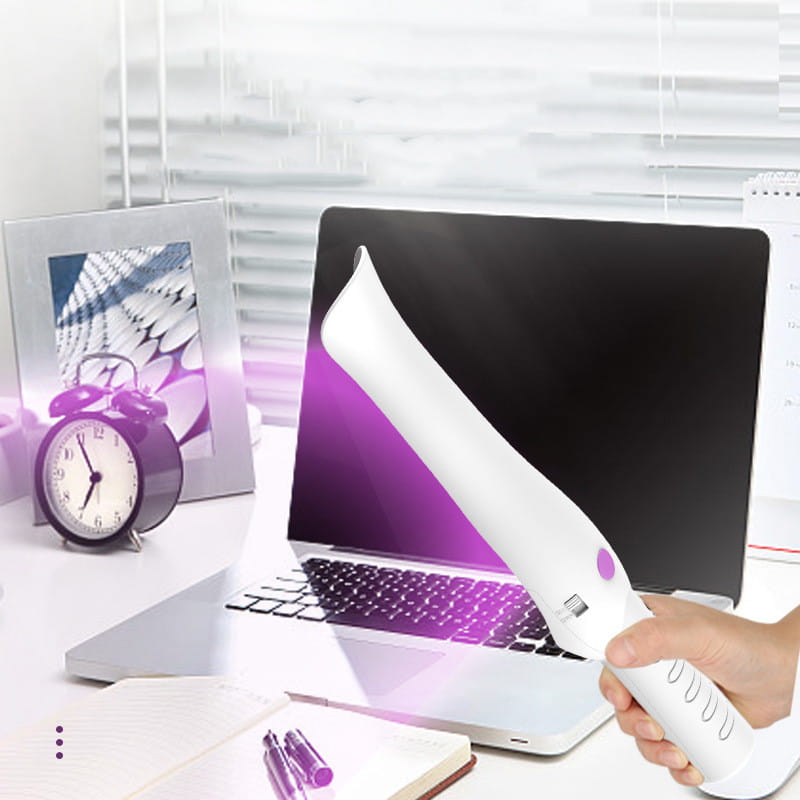 White handheld travel sterilization lamp stick with a purple accent button and textured grip designed for cleaning laptops and electronic devices.