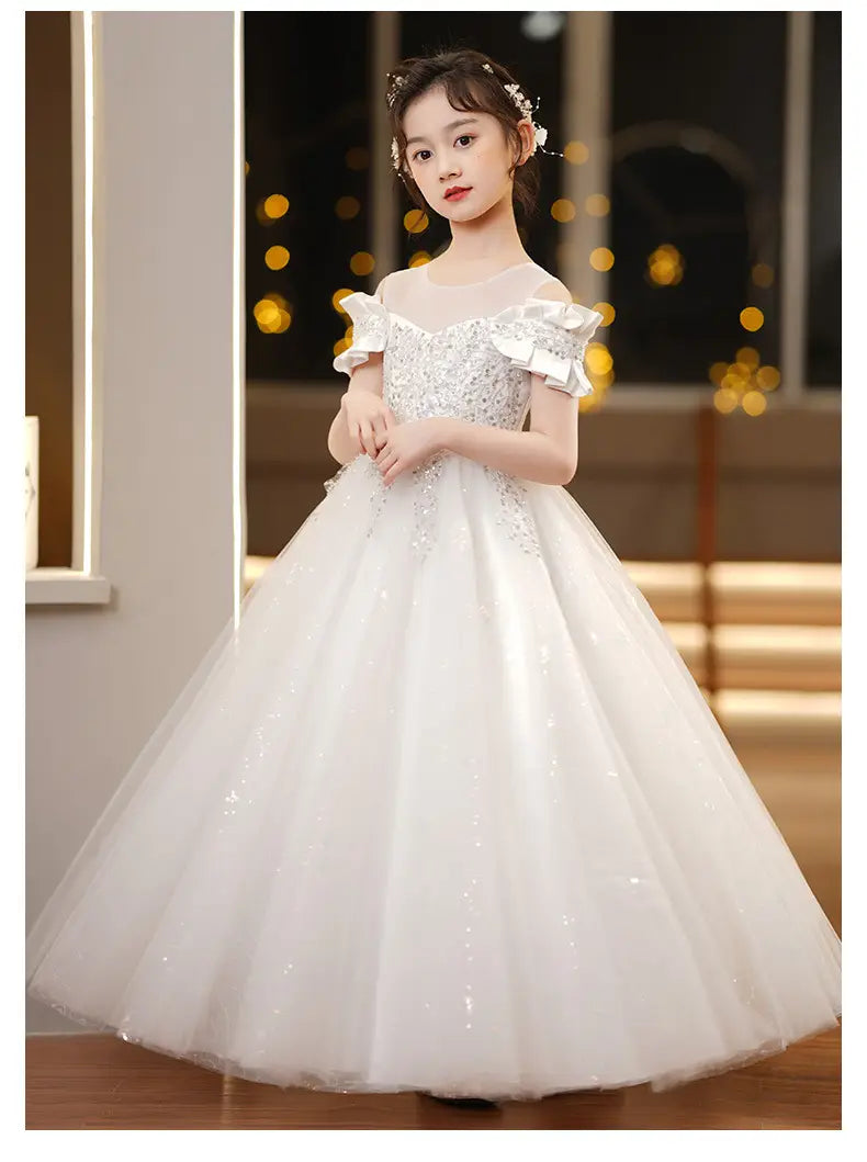 a white off-the-shoulder spandex princess dress with sparkling sequin embellishments and ruffled sleeves featuring a girls tulle tutu design
