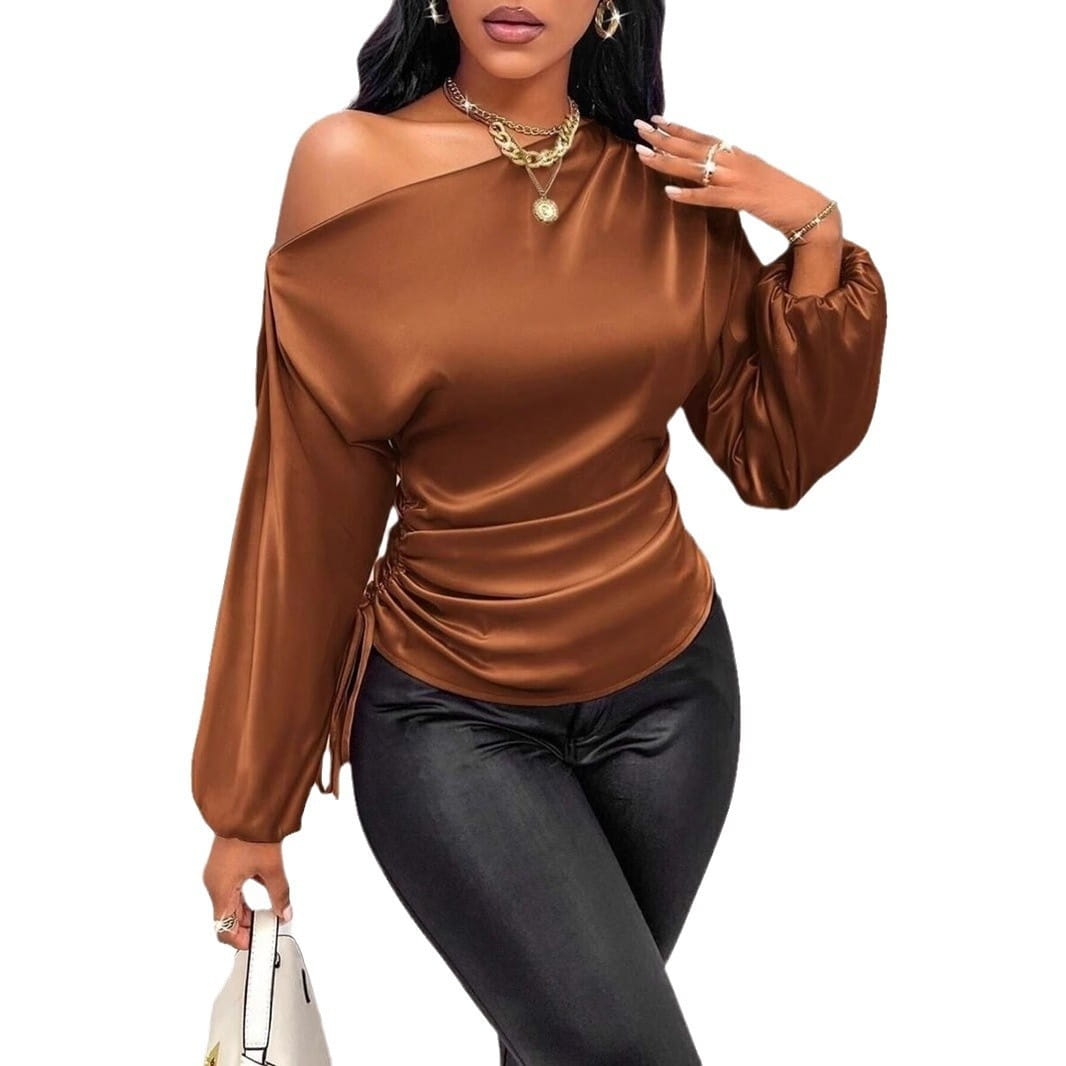 A sleek satin shirt asymmetric long sleeve top in brown with ruched detailing and voluminous sleeves.