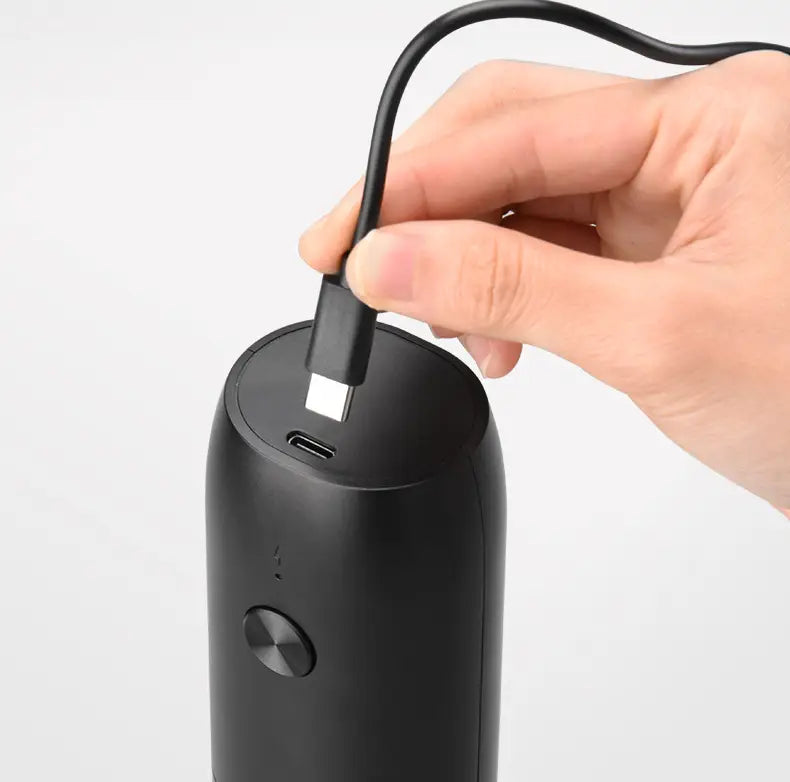 black cylindrical portable charger with usb-c port and circular power button for electric kitchen household grinder set use