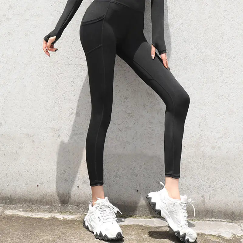 Black high-waisted gym sport seamless leggings with a sleek form-fitting design and subtle side pockets