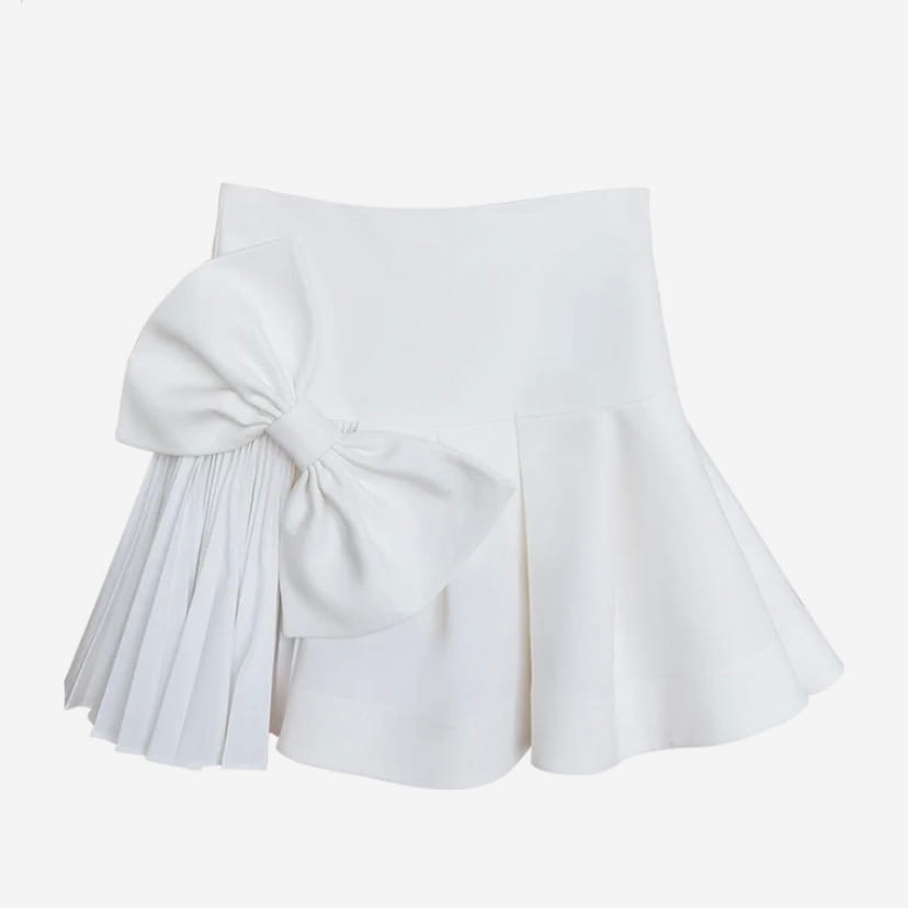 white high waist slimming pleated skirt with a large matching bow on the side