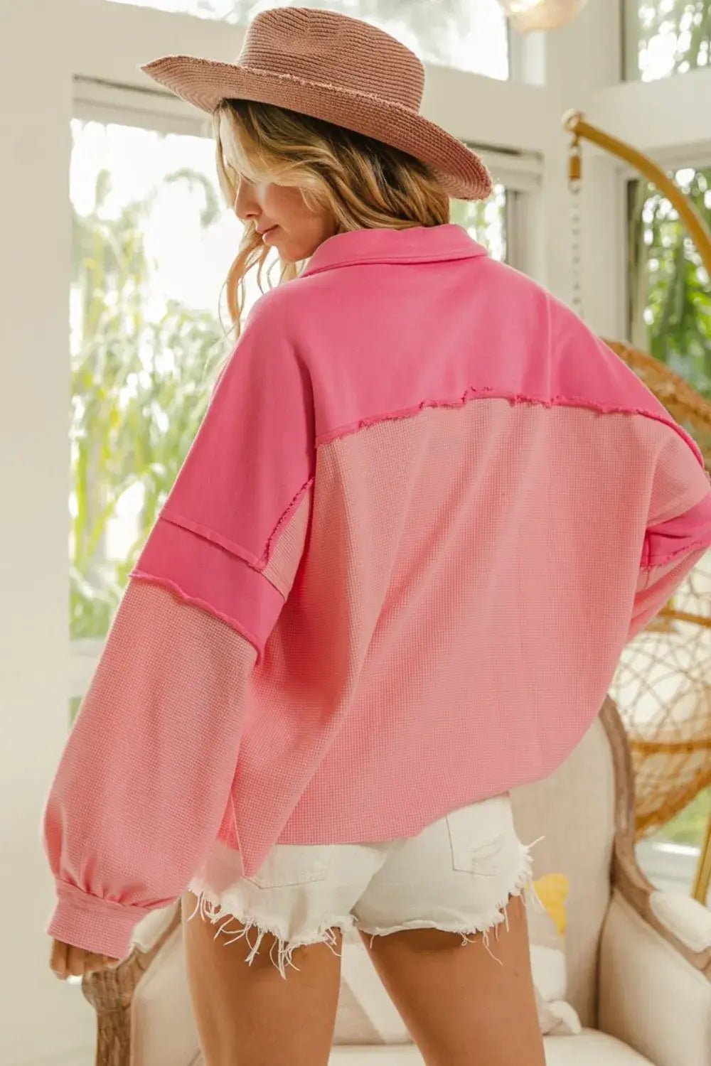 Oversized pink mixed thermal long sleeve knit sweatshirt featuring a two-tone ribbed fabric and frayed hem details.