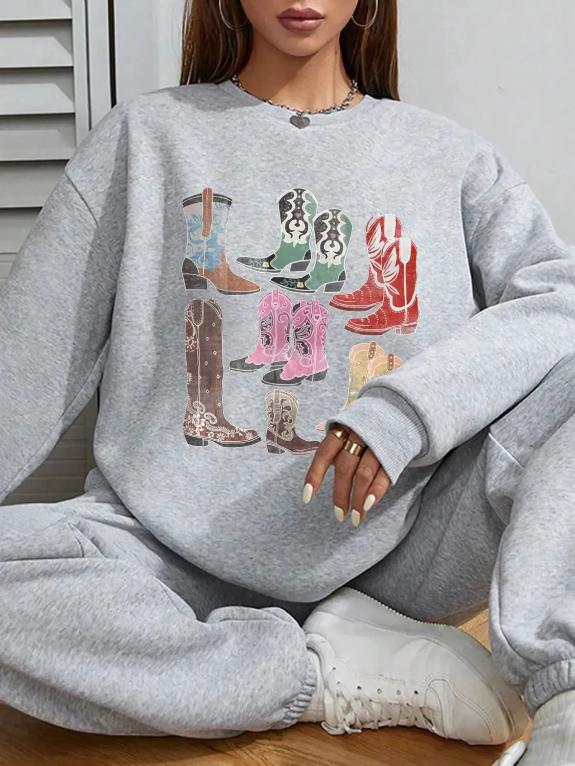 Gray oversized sweatshirt featuring a colorful cowboy boots print on a round neck pullover designed for women.