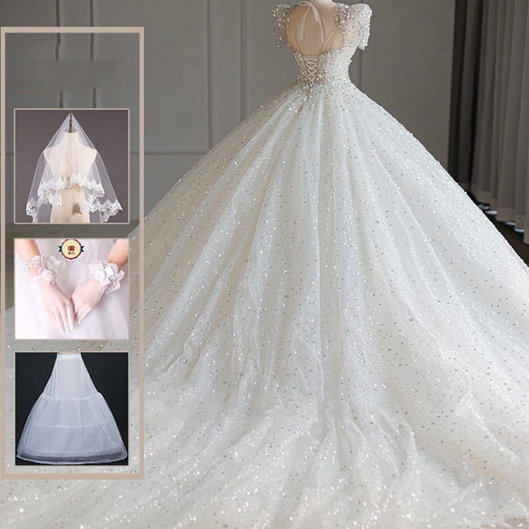 A sparkling beaded white wedding dress with intricate floral beading and a voluminous skirt perfect for a floral wedding dress look.