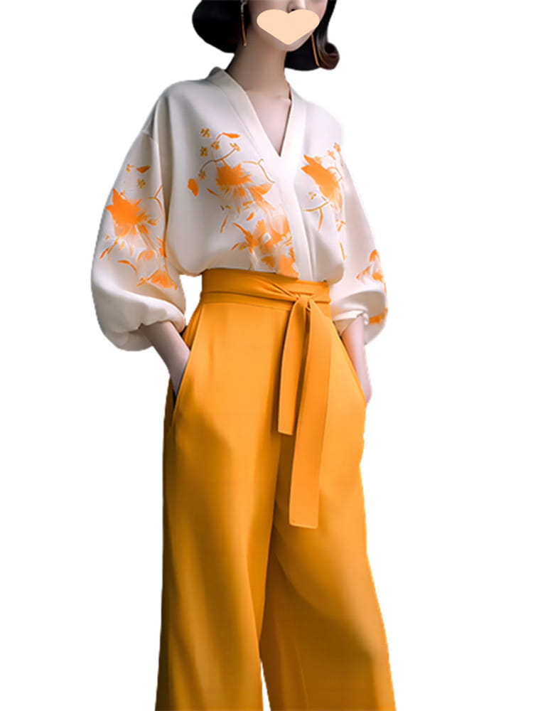 a flowing white silk blouse with orange floral embroidery and voluminous sleeves paired with high-waisted mustard-yellow wide-leg pants in a slimming wear flab hiding shirt set