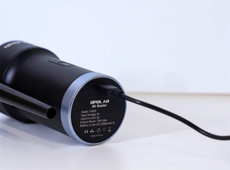 black opolar air duster with silver accent ring and black power cord shown as a household mini vacuum cleaner for efficient cleaning.