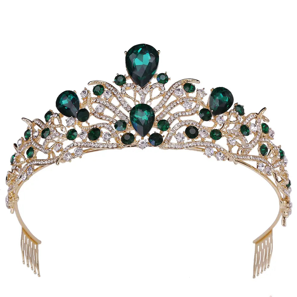 A gold-toned fashion bridal knot tiara adorned with emerald green teardrop and round crystals accented by smaller clear rhinestones.