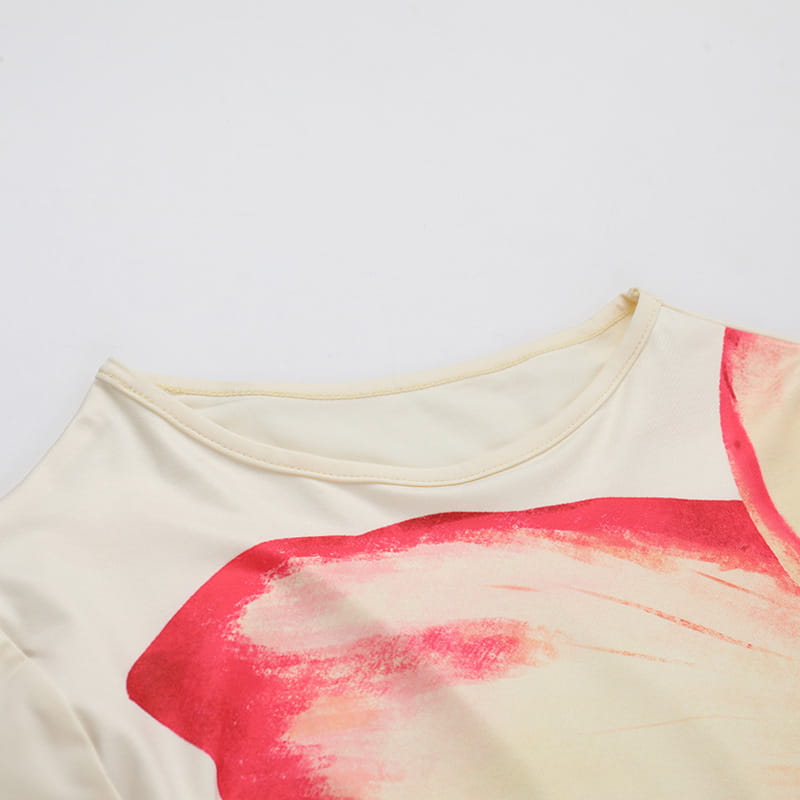 cream-colored elegant slim print t-shirt featuring a bold abstract red and pink brushstroke design across the chest with a slim print round neck.