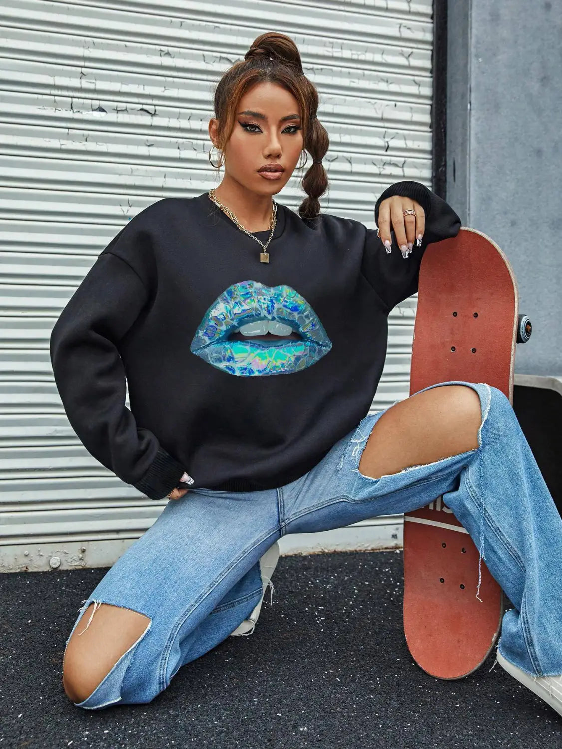 Black crew neck long sleeve sweatshirt featuring a vibrant blue and teal lips graphic across the chest.