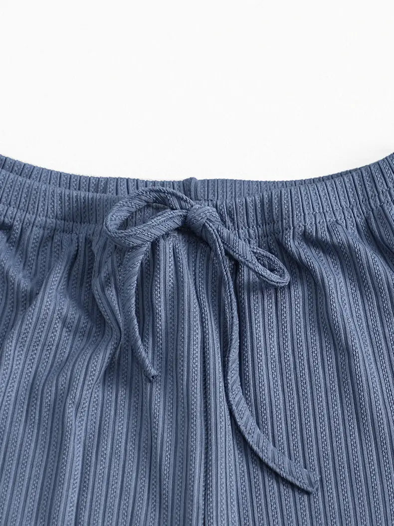 blue ribbed knit pajama pants with a drawstring waistband complement the black ribbed lace ruffle sleeve pajama set.