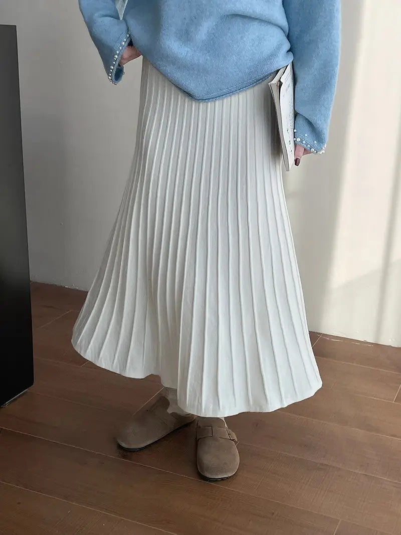 a flowing white pleated midi skirt made from soft textured fabric featuring a korean elastic waist knitted design for comfortable wear