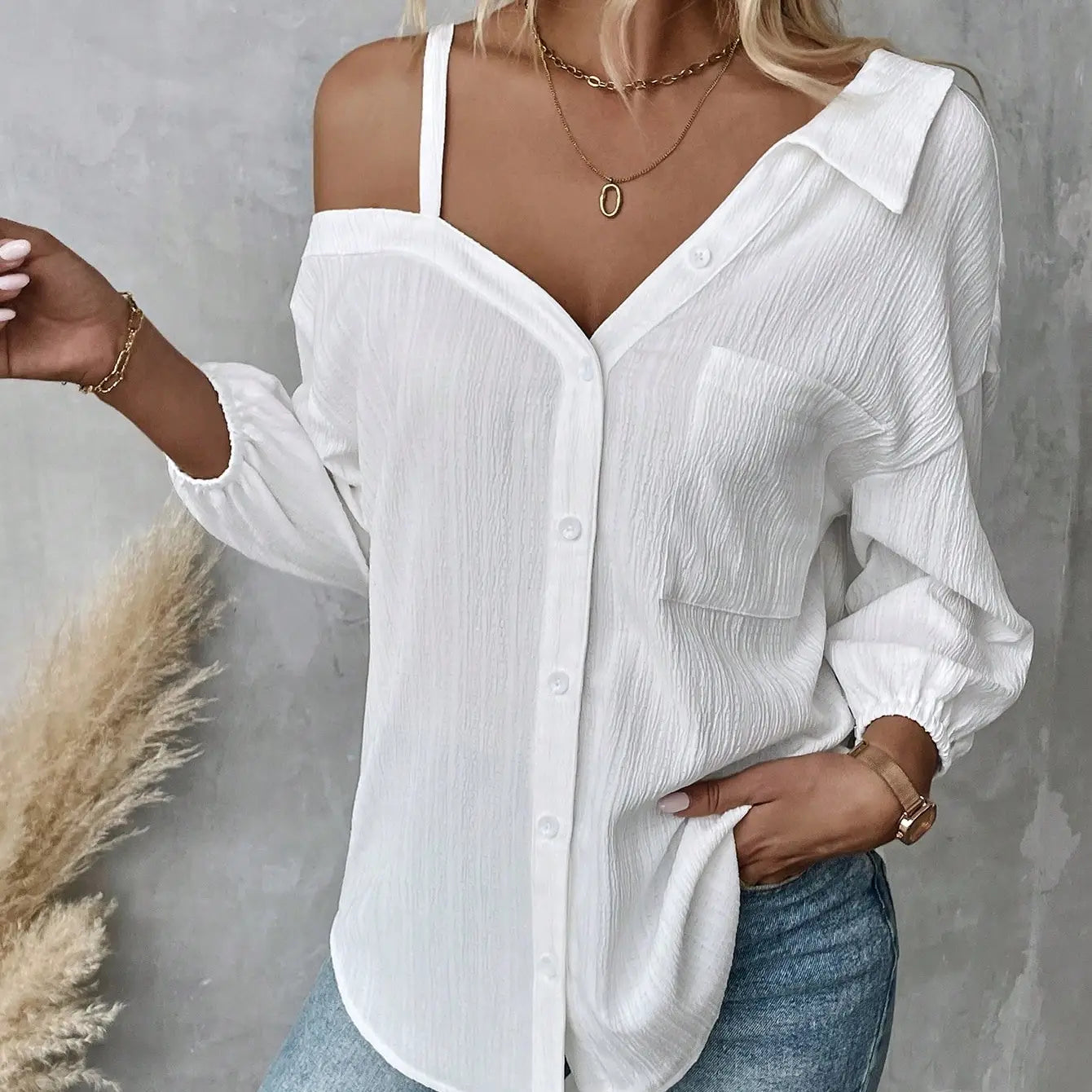 white asymmetric off shoulder blouse in solid color white with textured lightweight fabric and subtle pleats ideal for fall solid color styling.