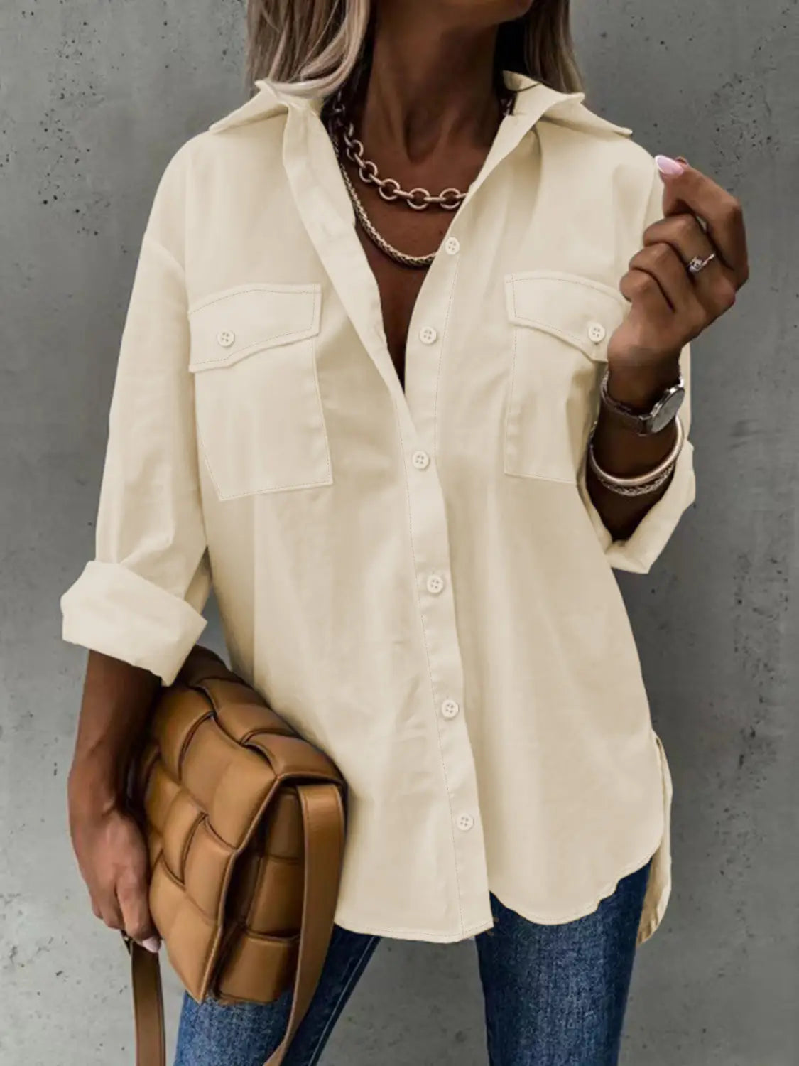 cream-colored loose long sleeve lapel button down shirt with two chest pockets and rolled sleeves designed for casual wear