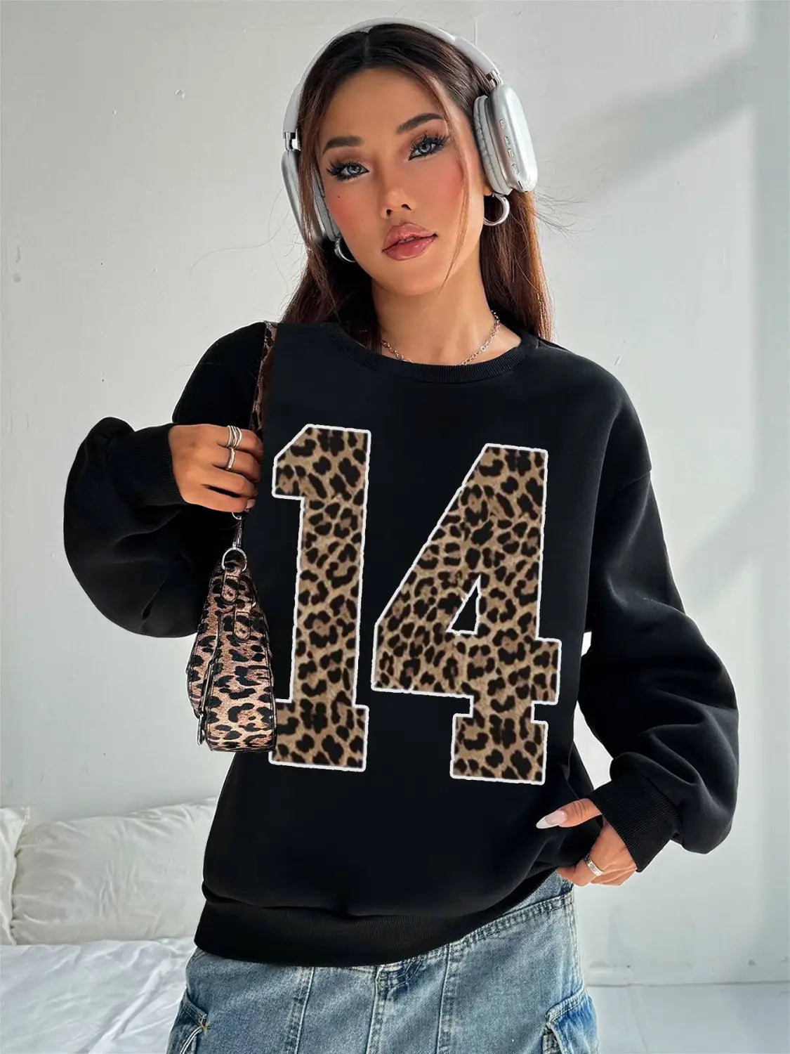 Black crew neck sweatshirt featuring a bold leopard print number 14 appliquéd across the front.