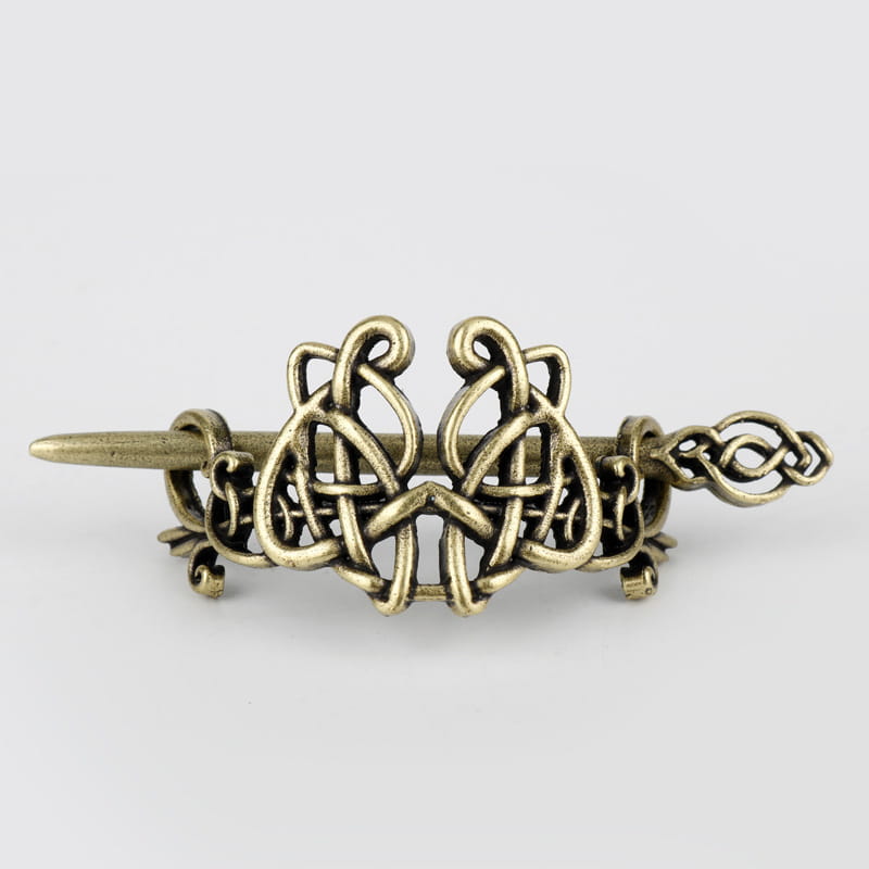 Antique brass-colored metal hair clip featuring intricate Celtic knotwork design as a decorative metal hair accessory.