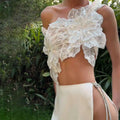 A delicate off-white lace crop top with floral appliqués and sparkling embellishments in a backless sequined lace split skirt suit