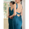 Back view of a backless strappy lake blue satin wedding dress with deep v-neckline and bow-tied straps