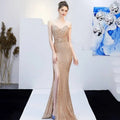A shimmering gold sequined mermaid gown with deep v-neckline and high slit for banquet elegant annual events