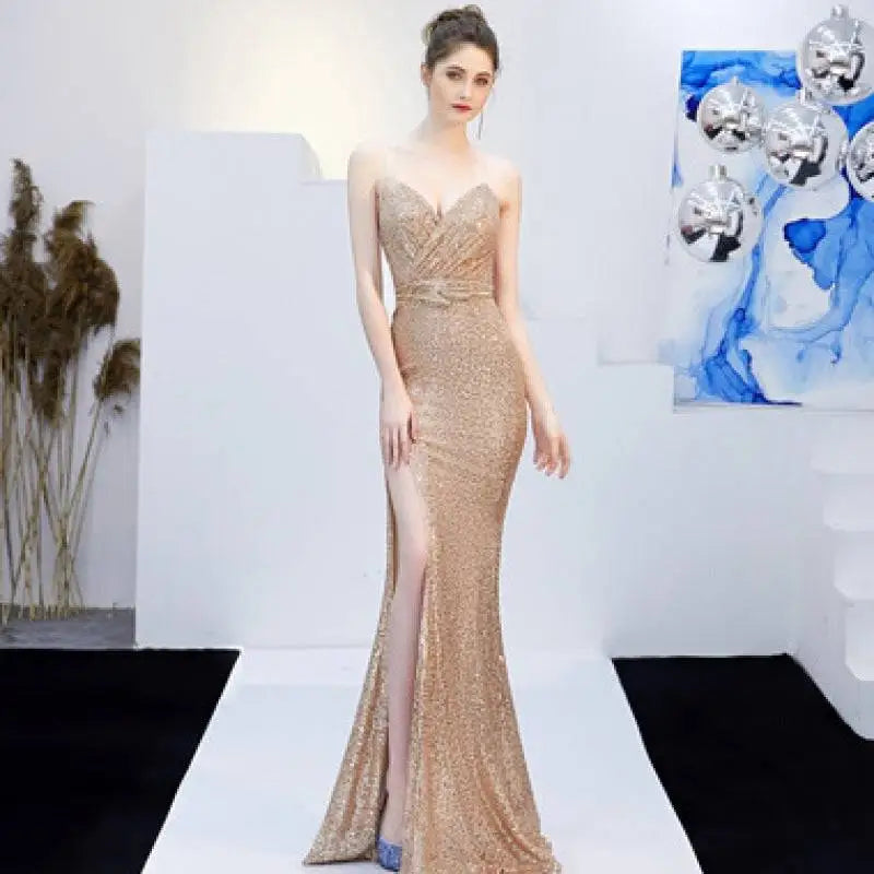 A shimmering gold sequined mermaid gown with deep v-neckline and high slit for banquet elegant annual events