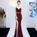 A shimmering burgundy sequined mermaid gown with a plunging v-neckline and high slit for banquet elegant annual events