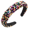 A black baroque colorful headband design adorned with multicolored shell fragments and sparkling gemstones