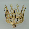 A baroque golden birthday crown tiara with intricate filigree detailing and black gemstones for cake decoration