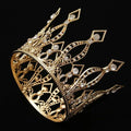 A baroque golden birthday crown tiara with intricate filigree detailing and sparkling clear crystal decoration