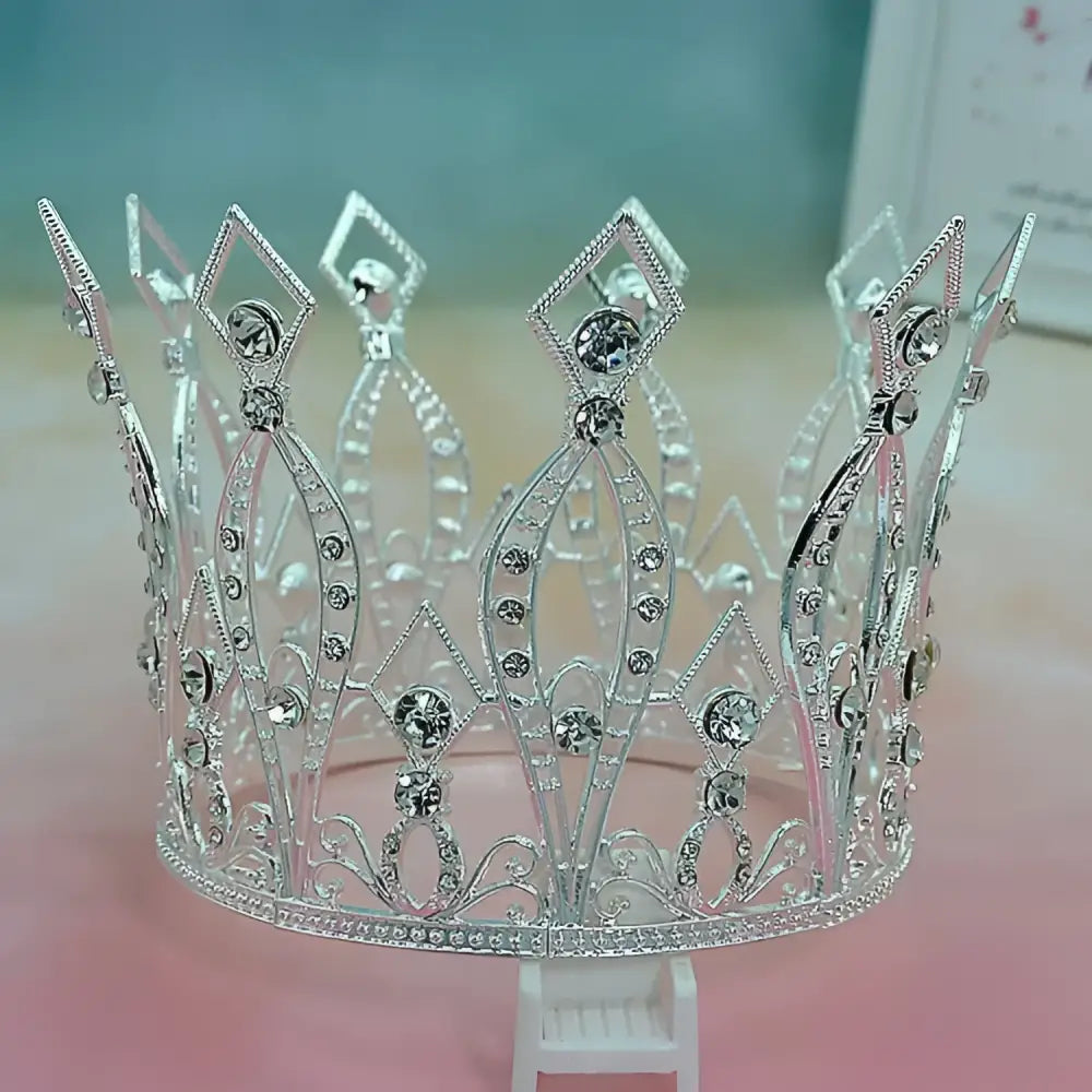 Silver tiara with sparkling rhinestones and intricate filigree detailing for baroque golden birthday crown cake decoration