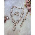A luxurious gold-toned necklace ring suit with irregular baroque pearls and crystal accents for bride ornament use