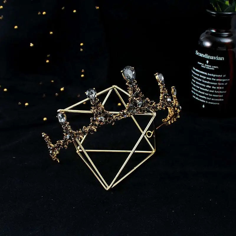 Gold-toned baroque vintage female crown adorned with clear crystals and intricate filigree as bridal jewelry
