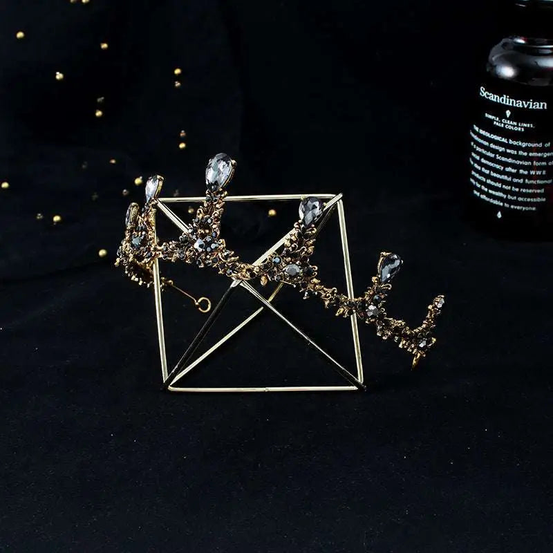 Gold-toned baroque vintage female crown adorned with sparkling clear crystals and intricate filigree bridal jewelry