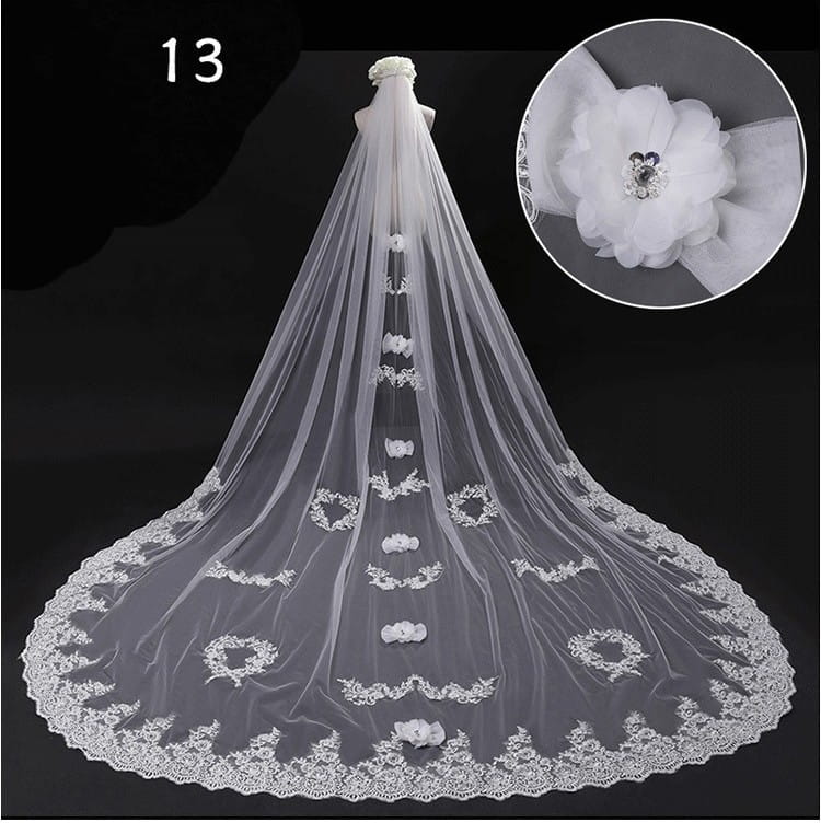 Elegant white lace wide style bridal wedding dress veil with delicate floral appliqués, a sparkling central embellishment, and a hair comb attachment.