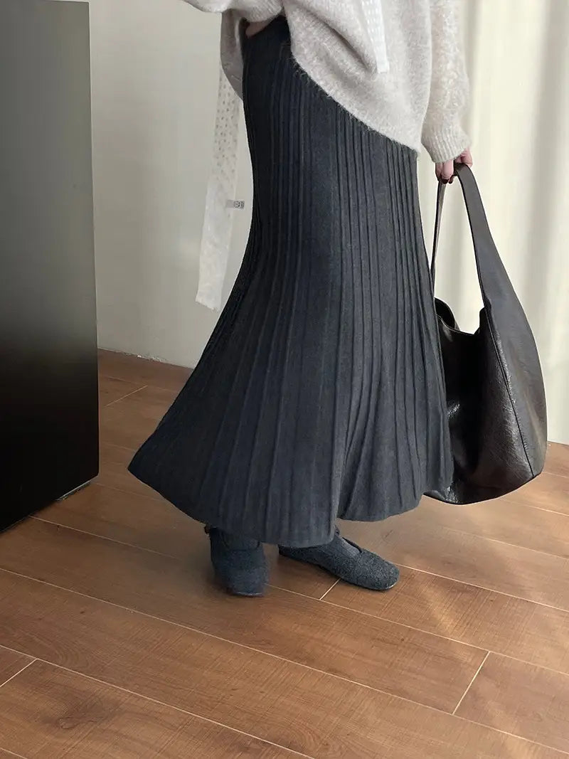 a dark gray korean elastic waist knitted pleated midi skirt with a ribbed texture and flowing silhouette