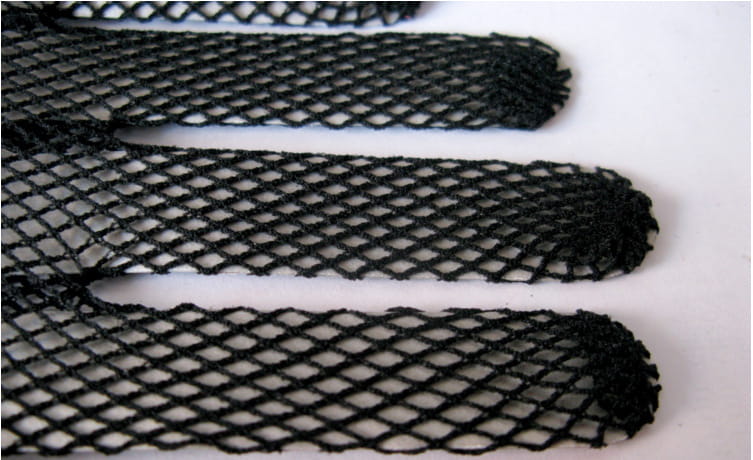 black fishnet stretch mesh gloves featuring a consistent diamond mesh pattern with frayed edges and lace cuffs, made from knitted stretch mesh material.