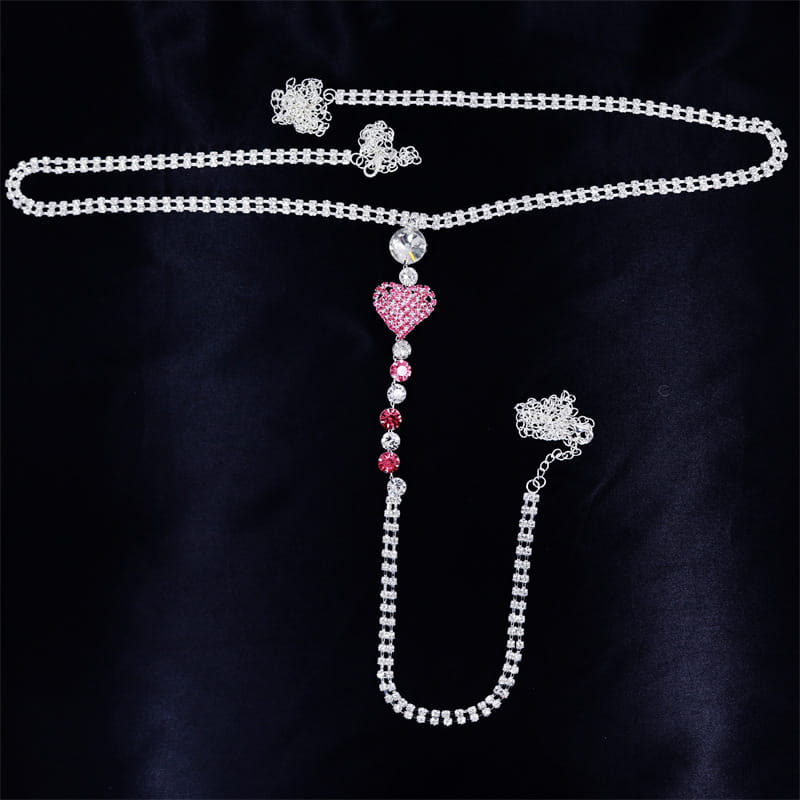 a sparkling silver chain belt heart rhinestone panty adorned with a pink rhinestone heart pendant and dangling crystal accents as panty body jewelry with garter belt