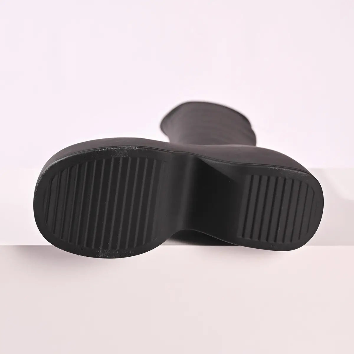 black platform elastic leather boots with thick ribbed rubber sole and knee high design