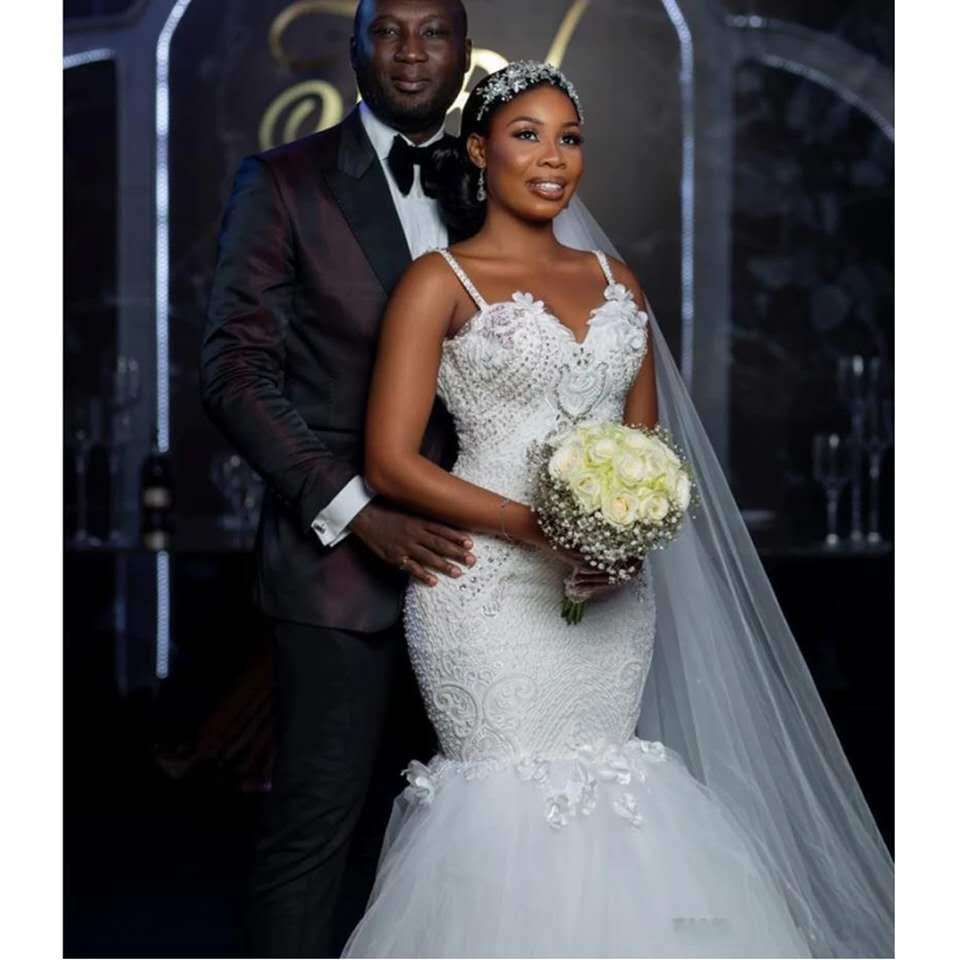 White lace sleeveless big tail African mermaid wedding dress featuring beaded detailing and a flowing tulle skirt made from main fabric lace.