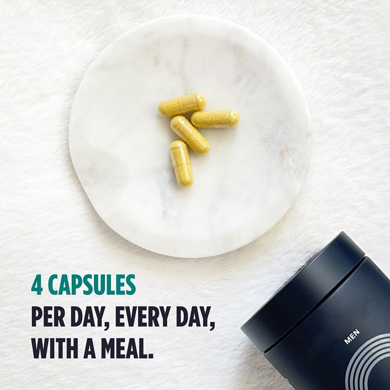 yellow hair care capsules resting on a white marble plate from a sealed 120 piece bottle for men hair care