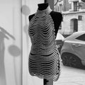 A shimmering silver beaded halter fashion party pearl chain dress with a cascading chainmail-like pattern