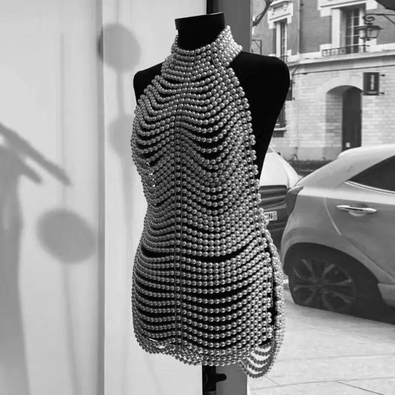 A shimmering silver beaded halter fashion party pearl chain dress with a cascading chainmail-like pattern