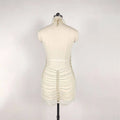 Back view of a shimmering white beaded halter fashion pearl chain dress with skeletal pearl strands for fashion party banquet
