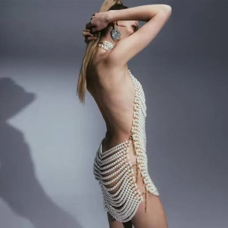 Back view of a shimmering white beaded halter fashion pearl chain dress with cascading pearls for fashion party banquet
