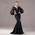 Elegant black beaded long sleeve fishtail gown with sheer puffy sleeves and intricate lace neckline detailing