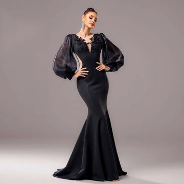 Elegant black beaded long sleeve fishtail gown with sheer puffy sleeves and intricate lace neckline detailing