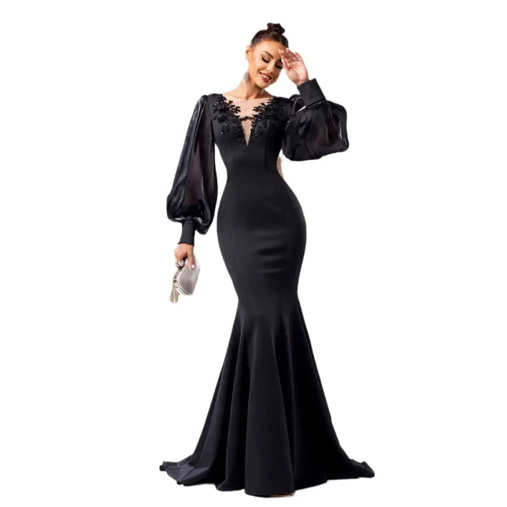 Elegant black fishtail gown with beaded long sleeve sheer puff sleeves and intricate lace neckline detailing