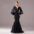 Elegant black fishtail gown with beaded long sleeve sheer puffy sleeves and intricate neckline embellishments